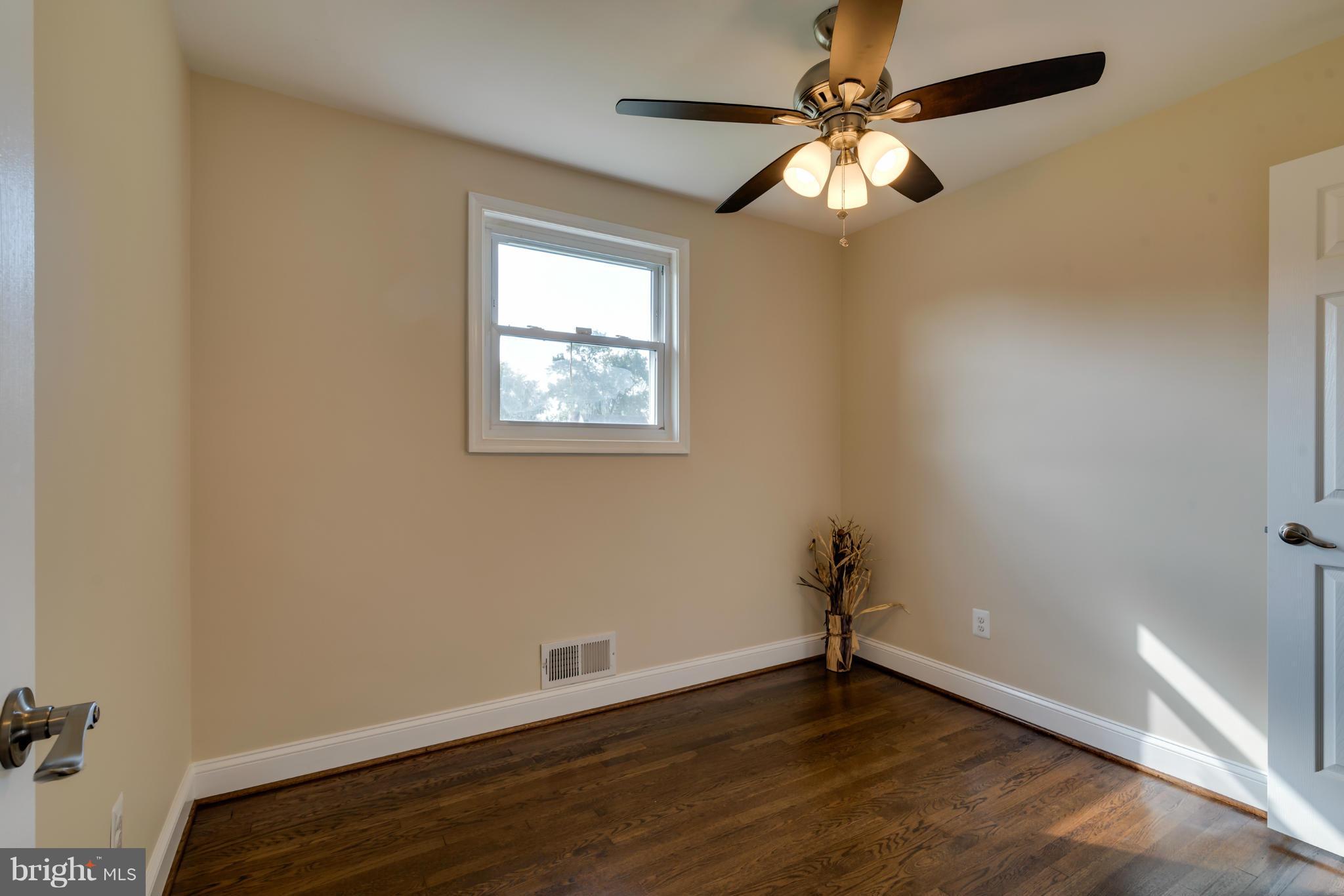3310 Harrell Street Silver Spring, MD 20906 - Photo 14 of 26 wooden floor in an empty room with a window