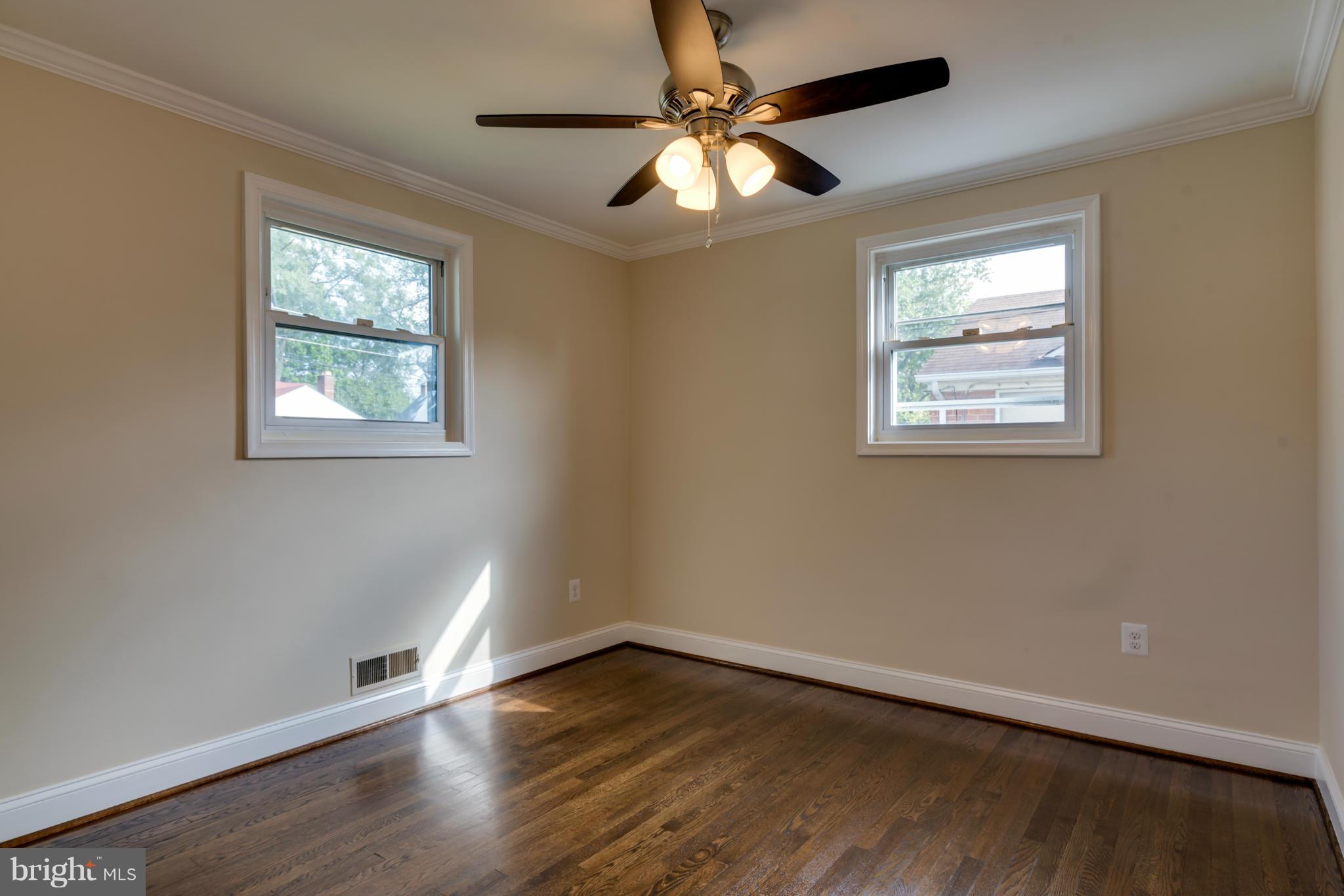 3310 Harrell Street Silver Spring, MD 20906 - Photo 15 of 26 a view of an empty room with wooden floor and a window