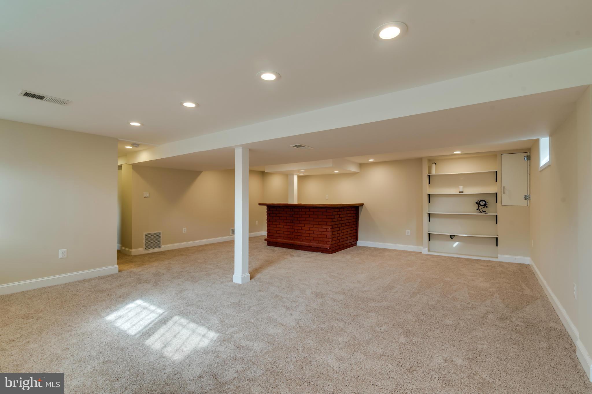 3310 Harrell Street Silver Spring, MD 20906 - Photo 19 of 26 an empty room with a fireplace and cabinet