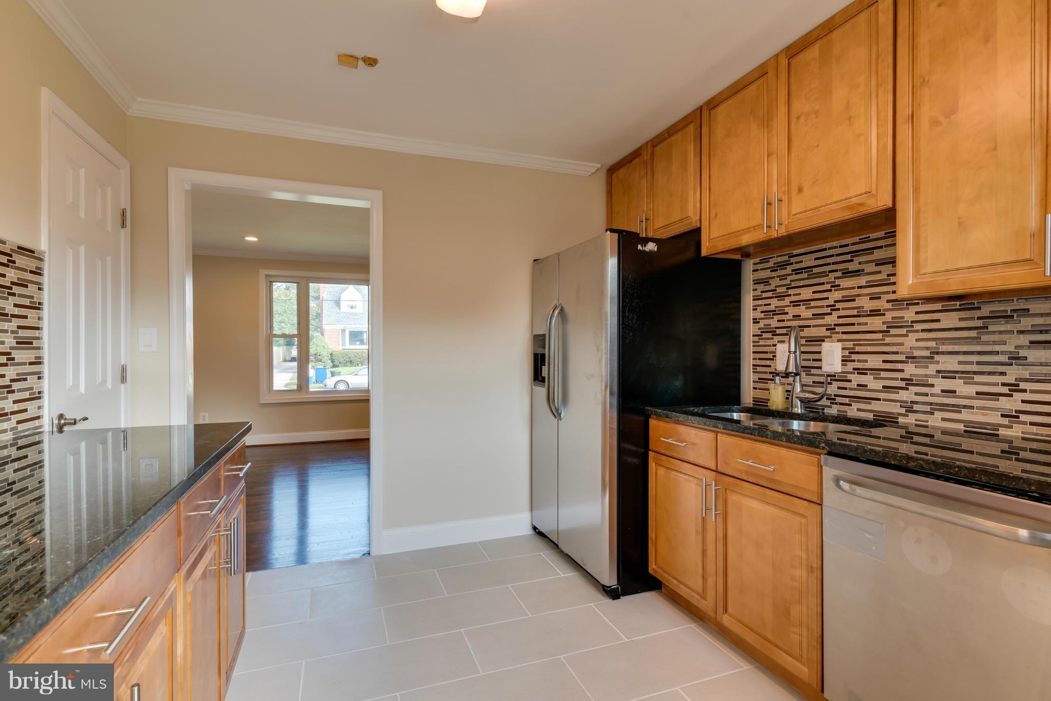 3310 Harrell Street Silver Spring, MD 20906 - Photo 3 of 26 a kitchen with stainless steel appliances granite countertop a refrigerator and a sink