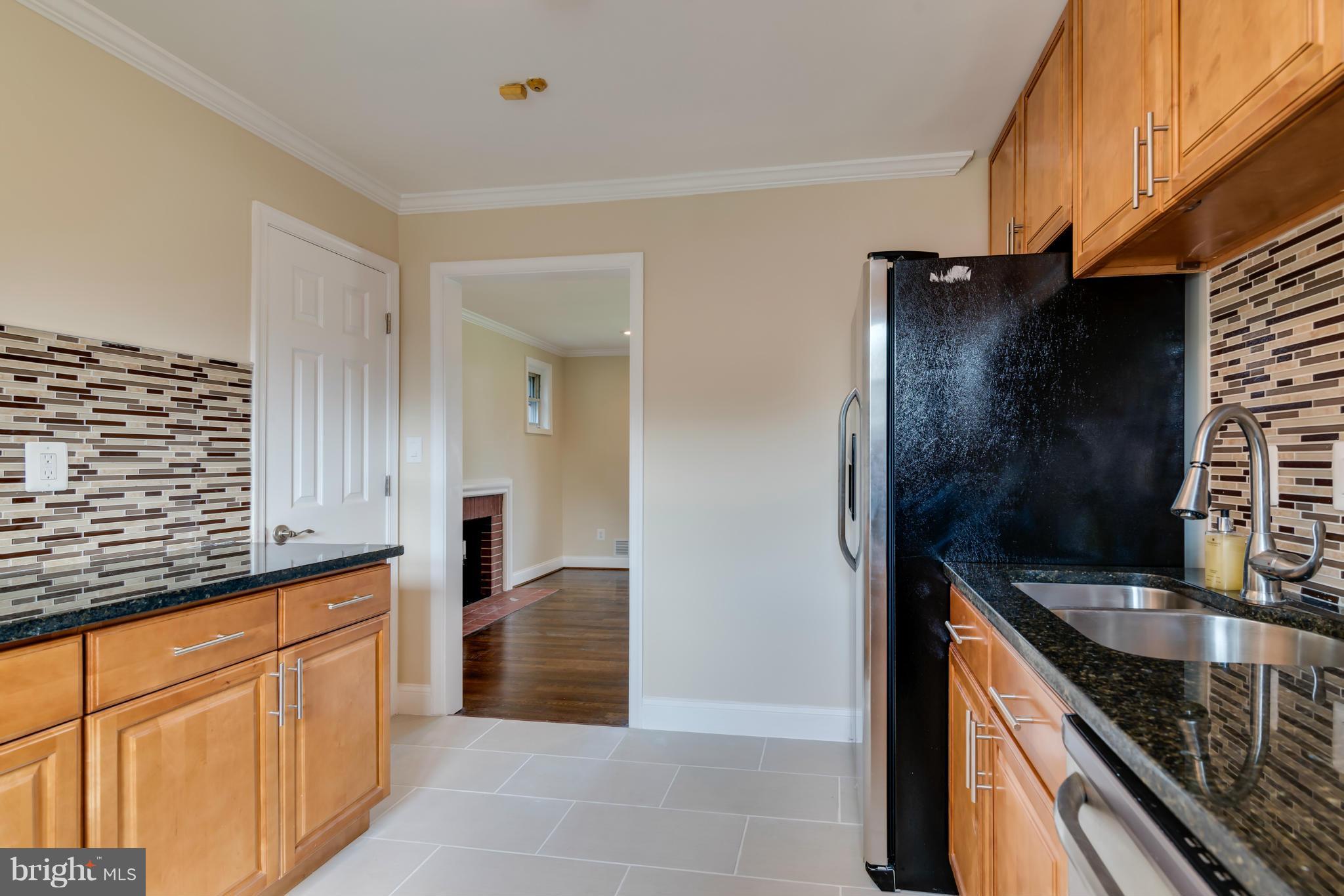 3310 Harrell Street Silver Spring, MD 20906 - Photo 5 of 26 a kitchen with stainless steel appliances granite countertop a sink and a stove
