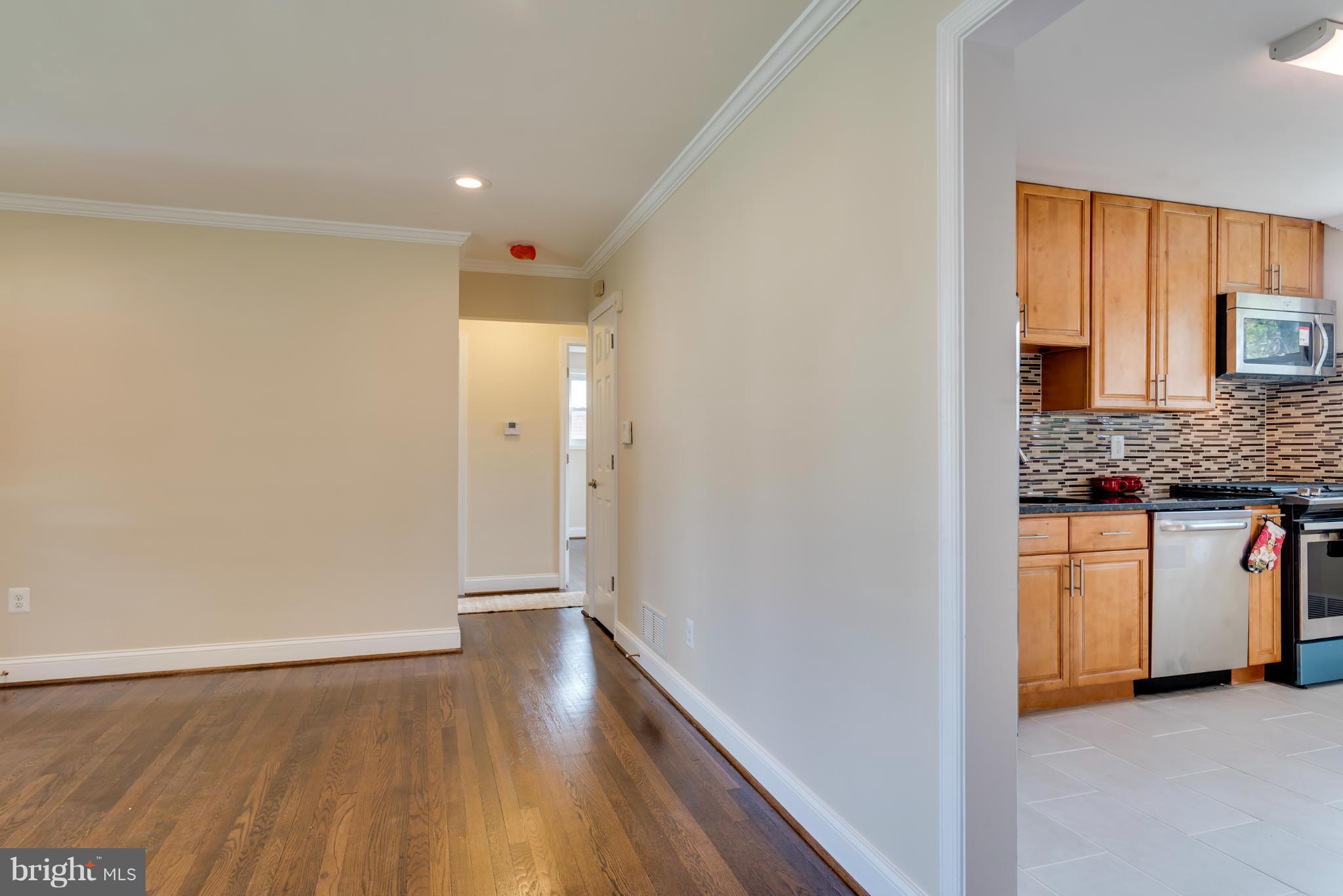 3310 Harrell Street Silver Spring, MD 20906 - Photo 7 of 26 a view of a kitchen cabinets a sink and a wooden floor