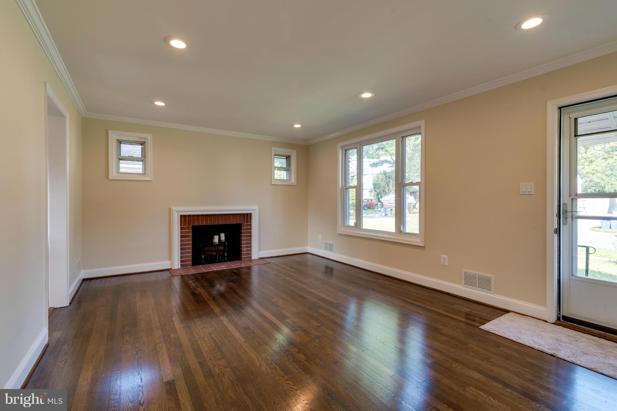 3310 Harrell Street Silver Spring, MD 20906 - Photo 8 of 26 a view of an empty room with wooden floor and a window