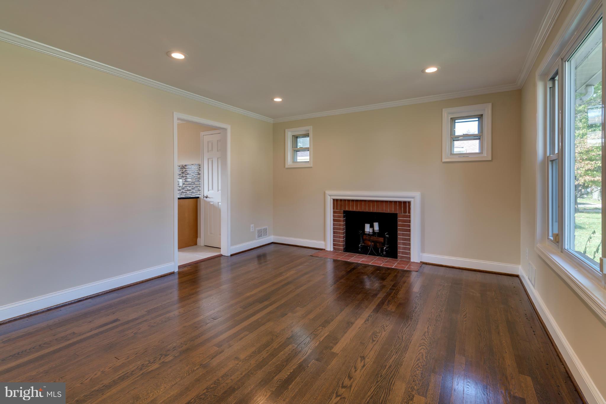 3310 Harrell Street Silver Spring, MD 20906 - Photo 9 of 26 a view of an empty room with wooden floor and a window