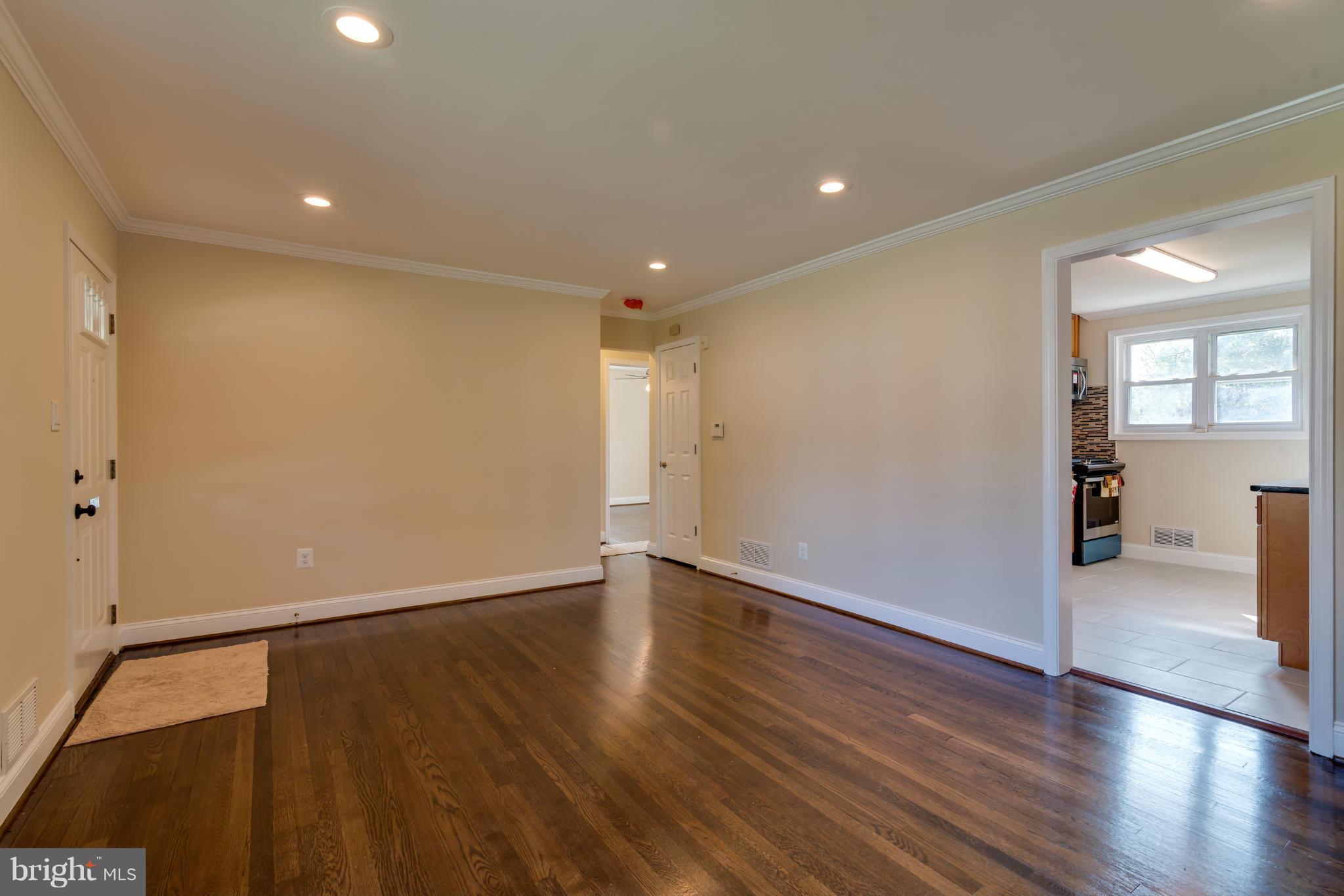3310 Harrell Street Silver Spring, MD 20906 - Photo 10 of 26 a view of an empty room with wooden floor and a window