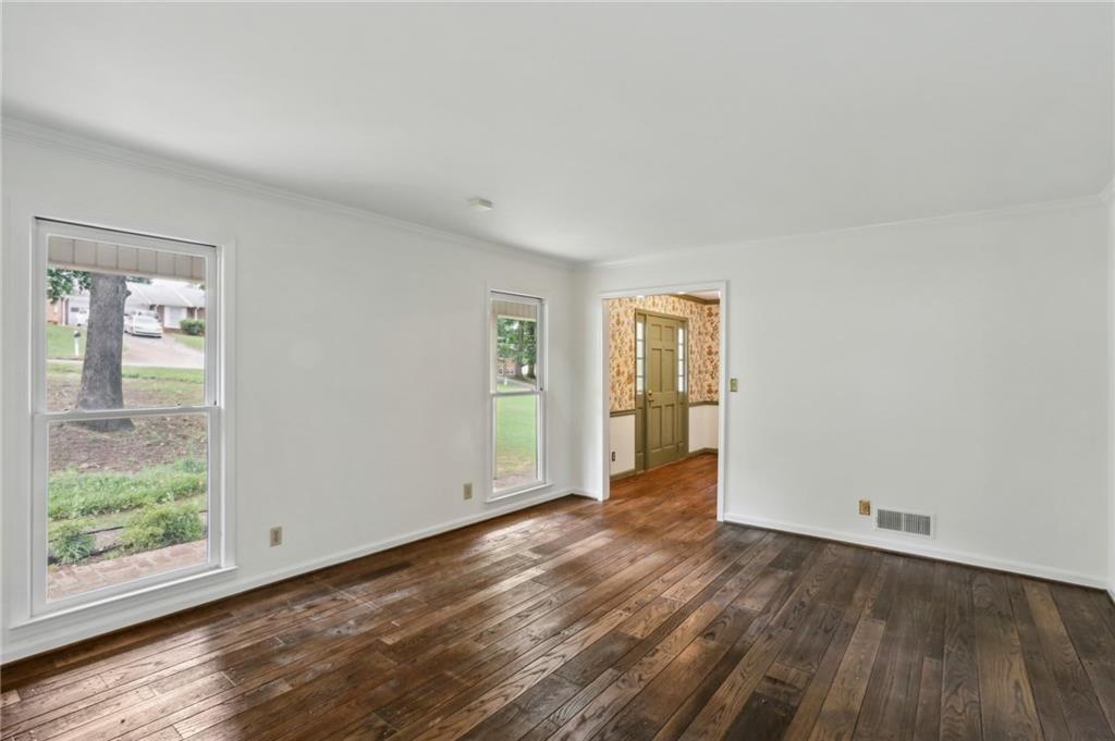 5622 Williamsburg Drive Northwest Norcross, GA 30093 - Photo 14 of 29 an empty room with wooden floor and windows