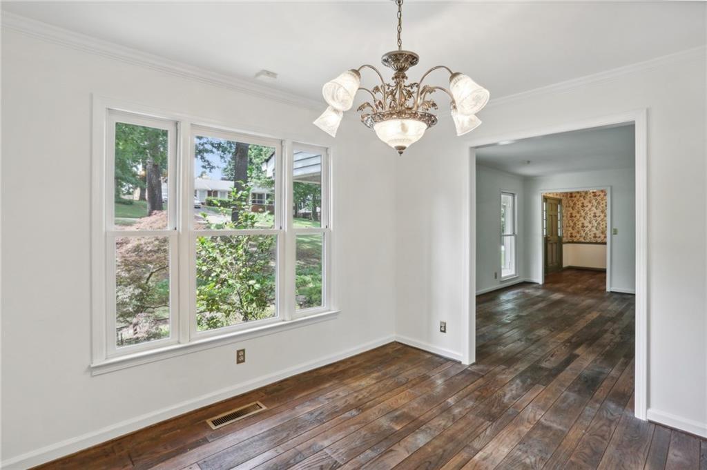 5622 Williamsburg Drive Northwest Norcross, GA 30093 - Photo 15 of 29 a view of a room with wooden floors and chandelier