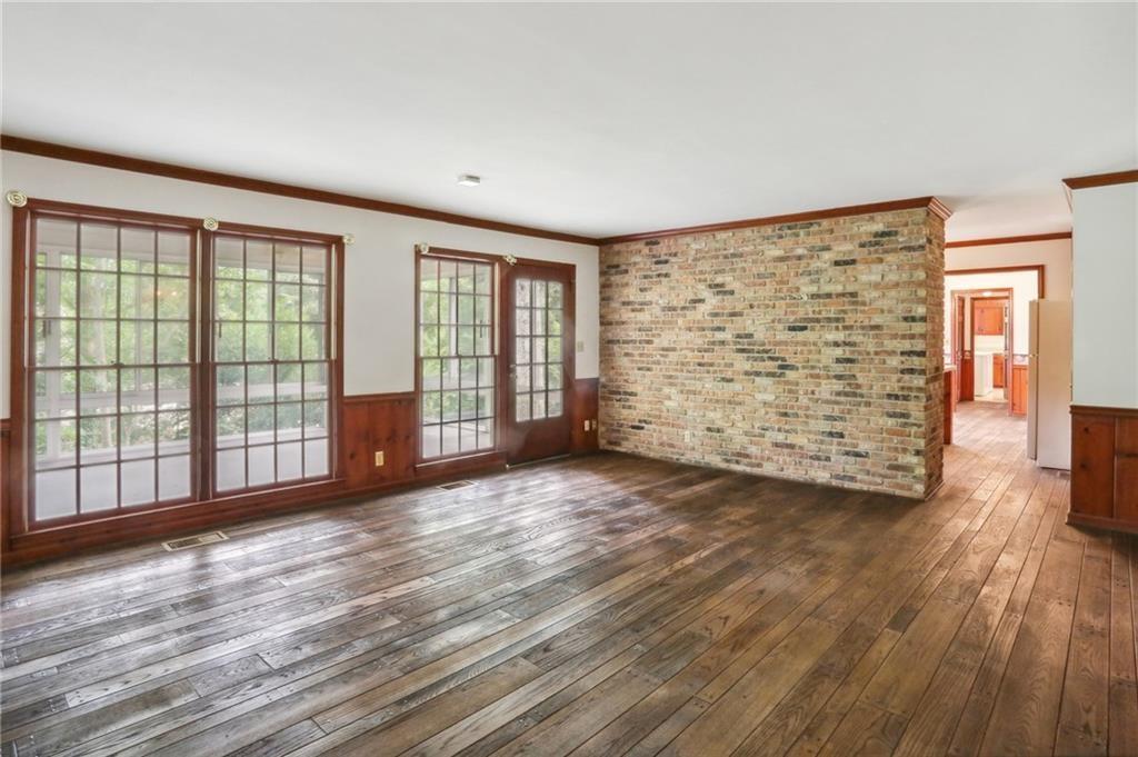 5622 Williamsburg Drive Northwest Norcross, GA 30093 - Photo 18 of 29 wooden floor in an empty room with a window