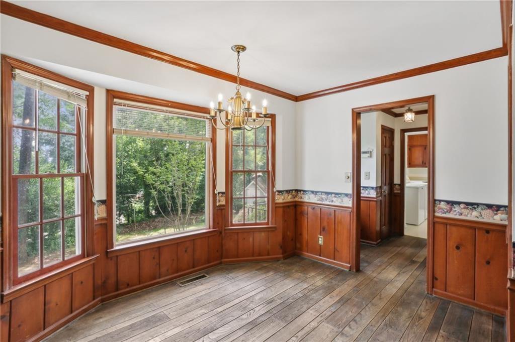 5622 Williamsburg Drive Northwest Norcross, GA 30093 - Photo 21 of 29 a view of an empty room with a window and wooden floor