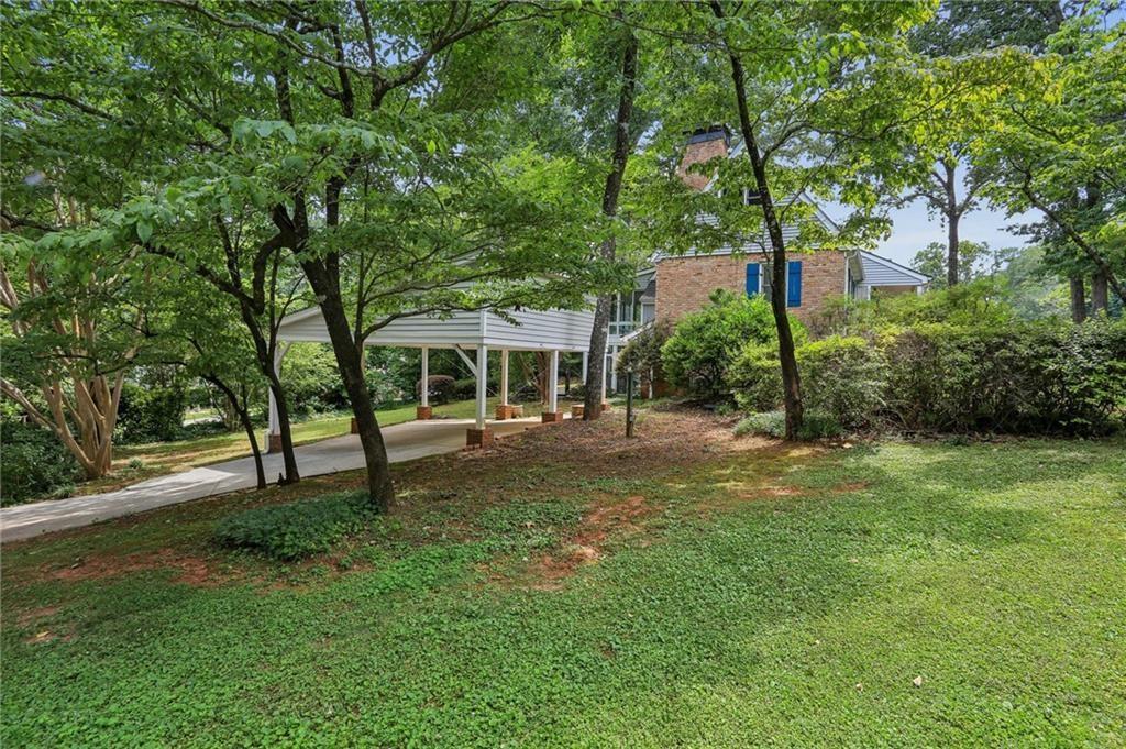 5622 Williamsburg Drive Northwest Norcross, GA 30093 - Photo 3 of 29 a front view of a house with a garden