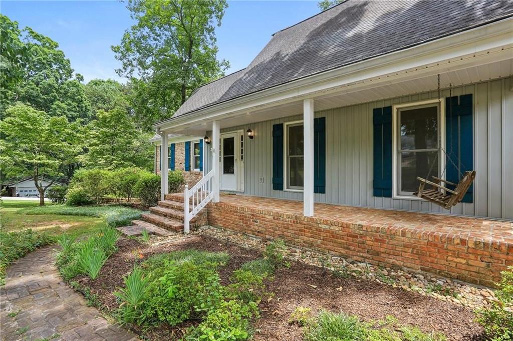 5622 Williamsburg Drive Northwest Norcross, GA 30093 - Photo 8 of 29 a view of a backyard with table and chairs and large tree