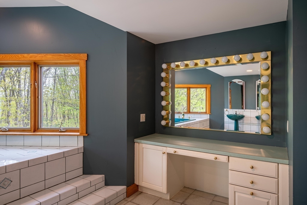 184 W Road Bernardston, MA 01337 - Photo 27 of 41 a living room with a large window and white cabinets
