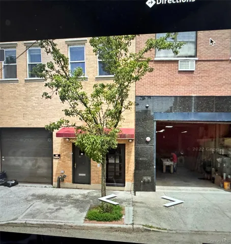 a front view of a building with small garden