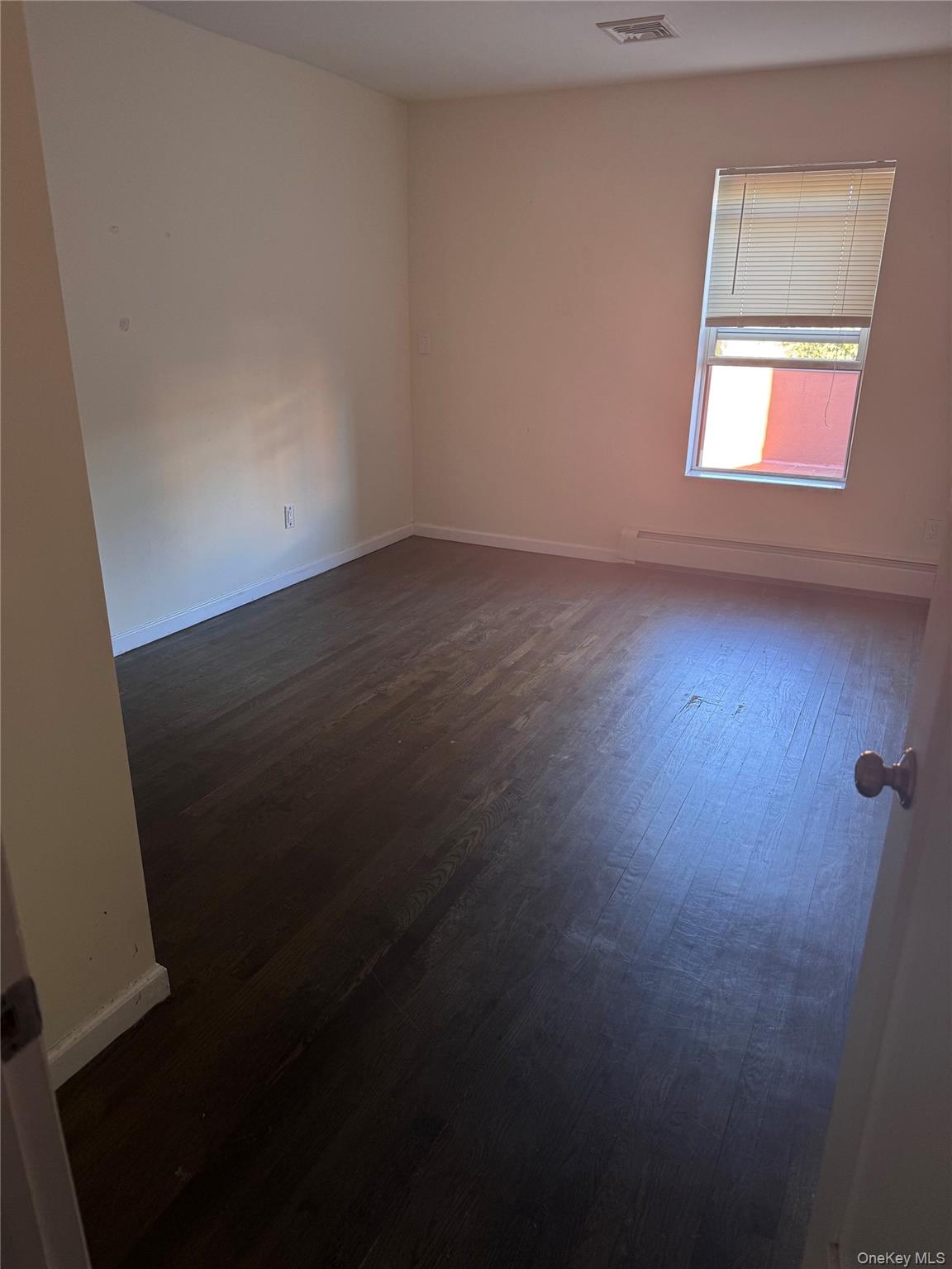 14-27 Astoria Boulevard Queens, NY 11102 - Photo 5 of 11 an empty room with a window
