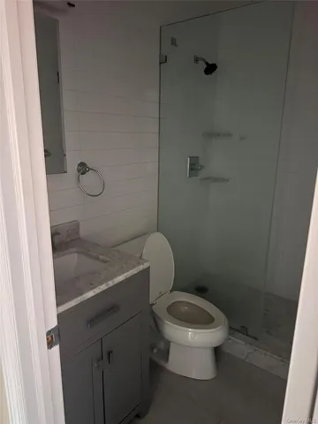 a white toilet sitting next to a bathroom sink