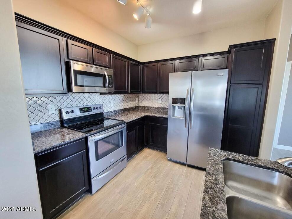 2150 West Alameda Road, Unit 1169 Phoenix, AZ 85085 - Photo 23 of 26 a kitchen with stainless steel appliances granite countertop a refrigerator a stove a sink and a microwave
