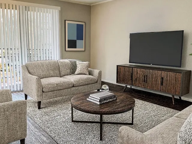 an empty room with wooden floor and closet area