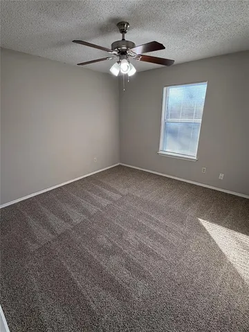 a view of a livingroom with a ceiling fan and window