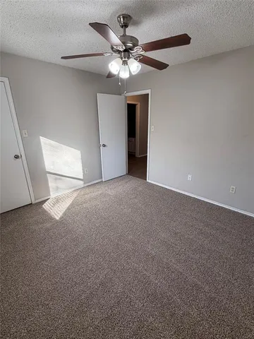 a view of a livingroom with a ceiling fan and window