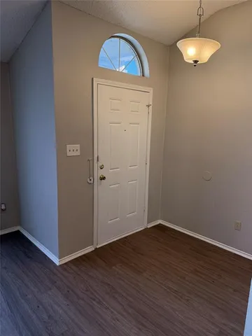 an empty room with wooden floor closet and chandelier fan