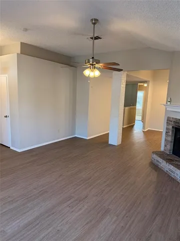 a view of a room with wooden floor and chandelier