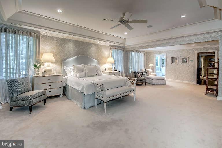 5511 Cornish Road Bethesda, MD 20814 - Photo 17 of 30 a spacious bedroom with a bed a couch and a chandelier