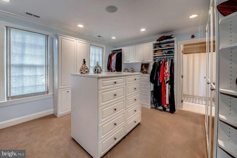 5511 Cornish Road Bethesda, MD 20814 - Photo 22 of 30 a view of walk in closet with clothes and shoes