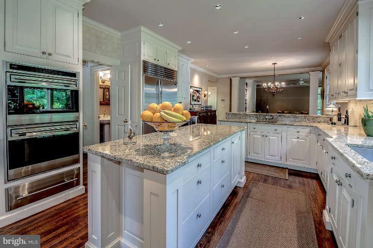 5511 Cornish Road Bethesda, MD 20814 - Photo 9 of 30 a kitchen with stainless steel appliances granite countertop a sink and a stove