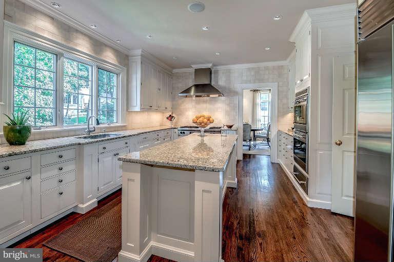 5511 Cornish Road Bethesda, MD 20814 - Photo 10 of 30 a kitchen with granite countertop a large counter top space a sink stainless steel appliances and cabinets
