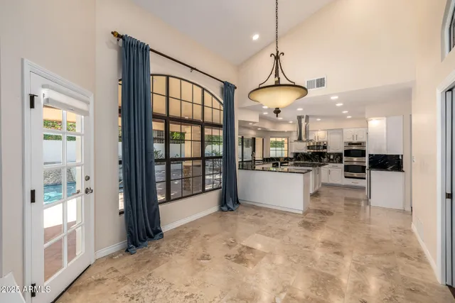 a kitchen with sink large window and cabinets