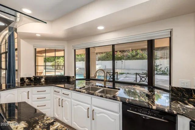 a kitchen with stainless steel appliances kitchen island granite countertop a sink and cabinets