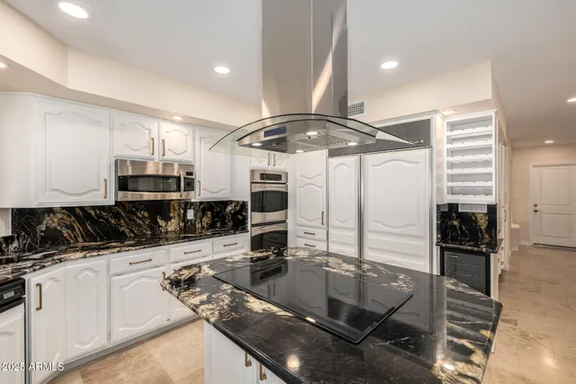 a kitchen with stainless steel appliances a stove and a refrigerator
