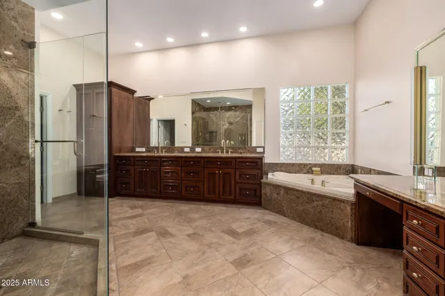 a bathroom with a granite countertop sink double and mirror