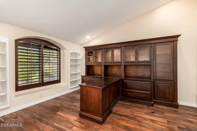 a view of an empty room and wooden floor