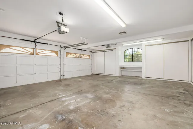 a view of a backyard with table and chairs and potted plants