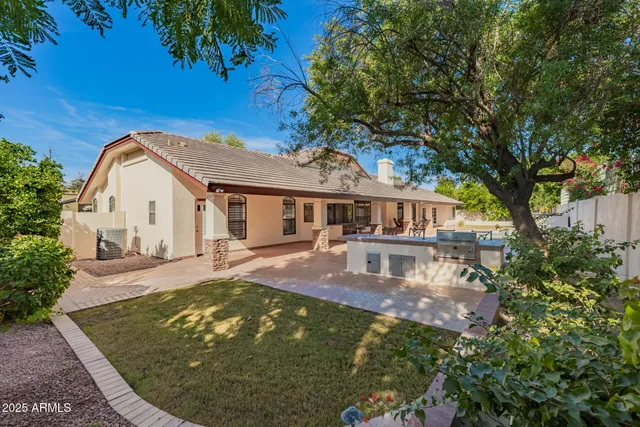 a view of a patio with table and chairs with wooden fence and plants