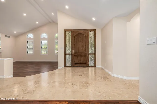 an empty room with wooden floor and fireplace
