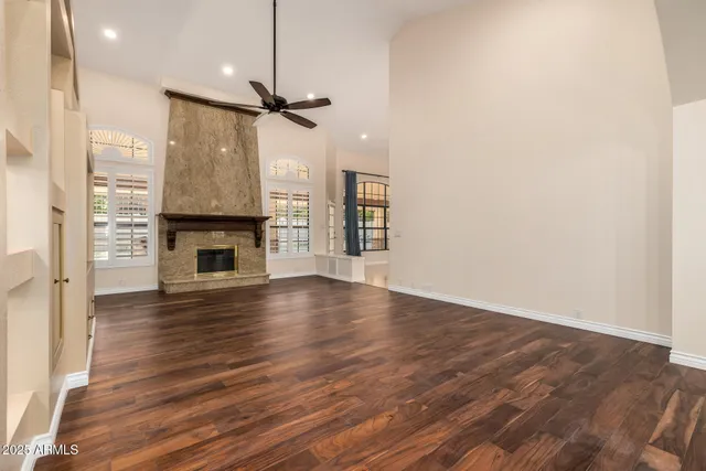 wooden floor in an empty room with a fireplace