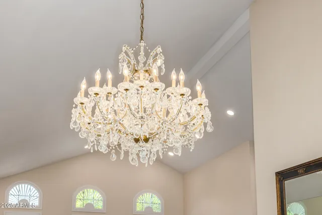 a view of an empty room with wooden floor and a large window