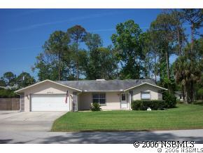 2704 Unity Tree Drive Edgewater, FL 32141 - Photo 1 of 6 a front view of a house with a yard and garage