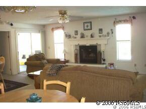 2704 Unity Tree Drive Edgewater, FL 32141 - Photo 3 of 6 a living room with furniture a window and a fireplace