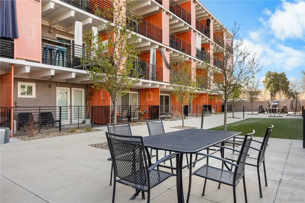 a view of a building with a table and chairs