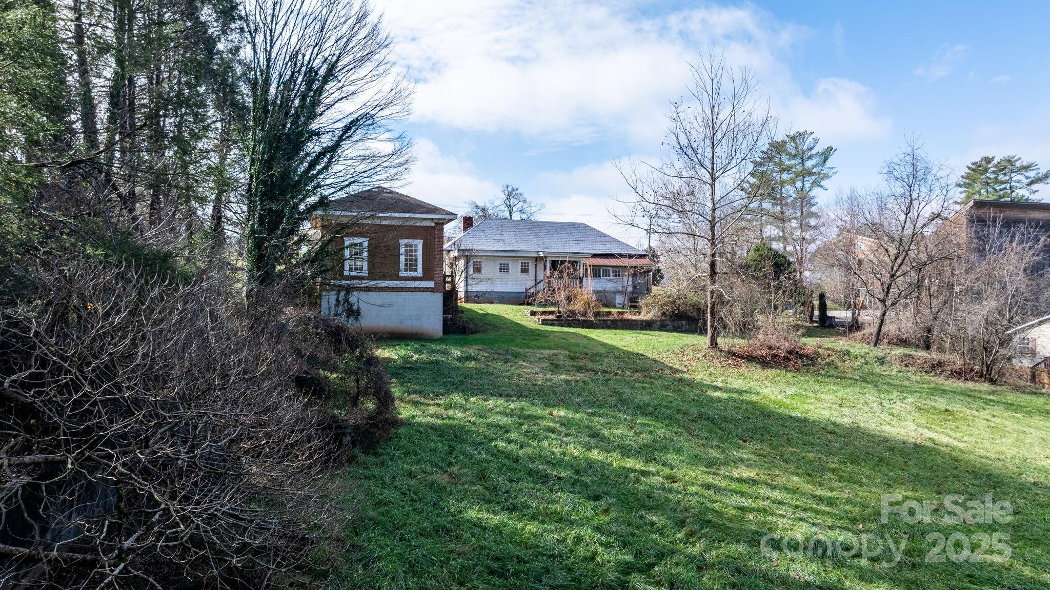 335 Eastview Street Morganton, NC 28655 - Photo 11 of 34 a view of house in front of a big yard with large trees