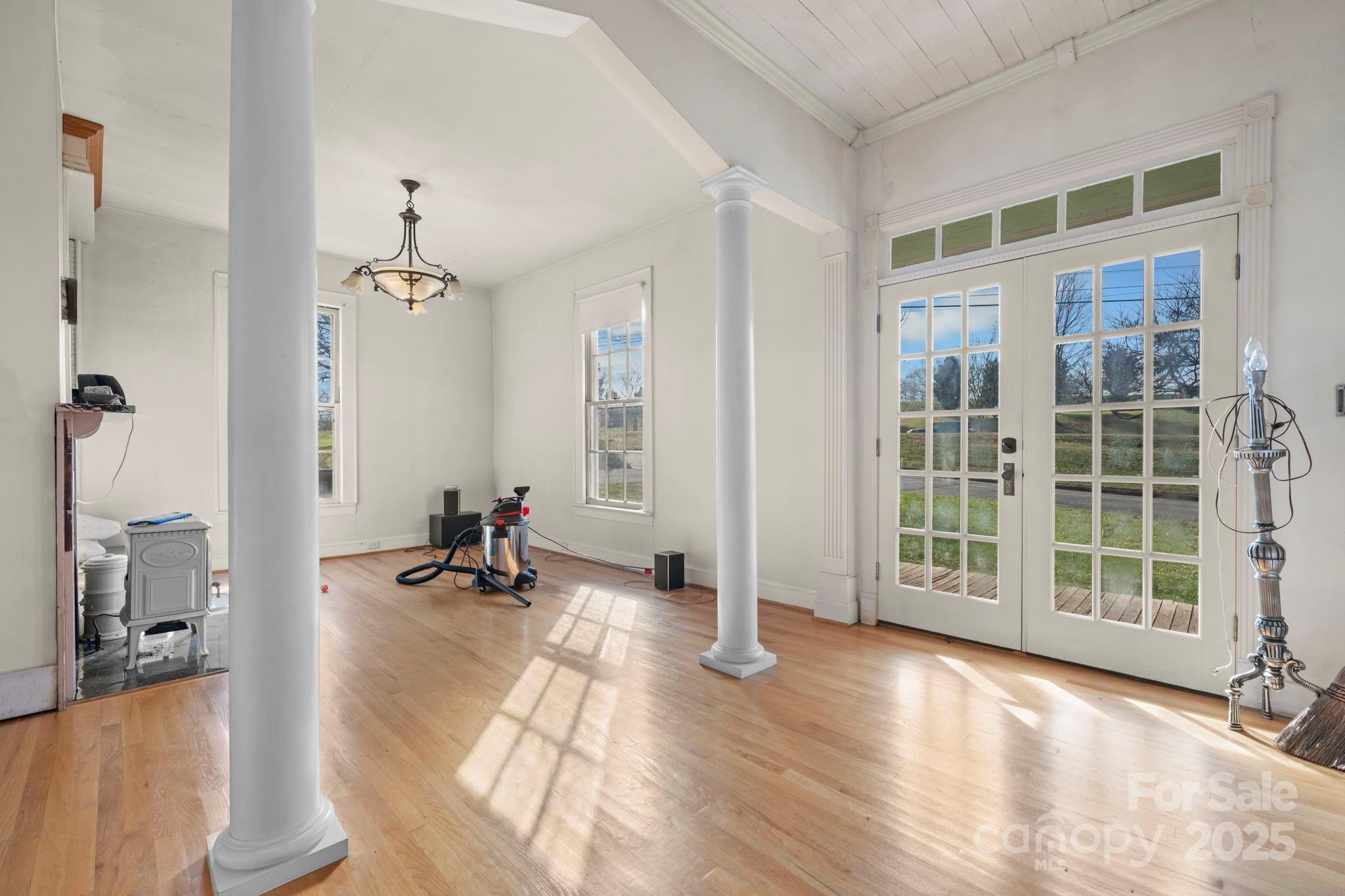 335 Eastview Street Morganton, NC 28655 - Photo 16 of 34 an empty room with wooden floor and windows