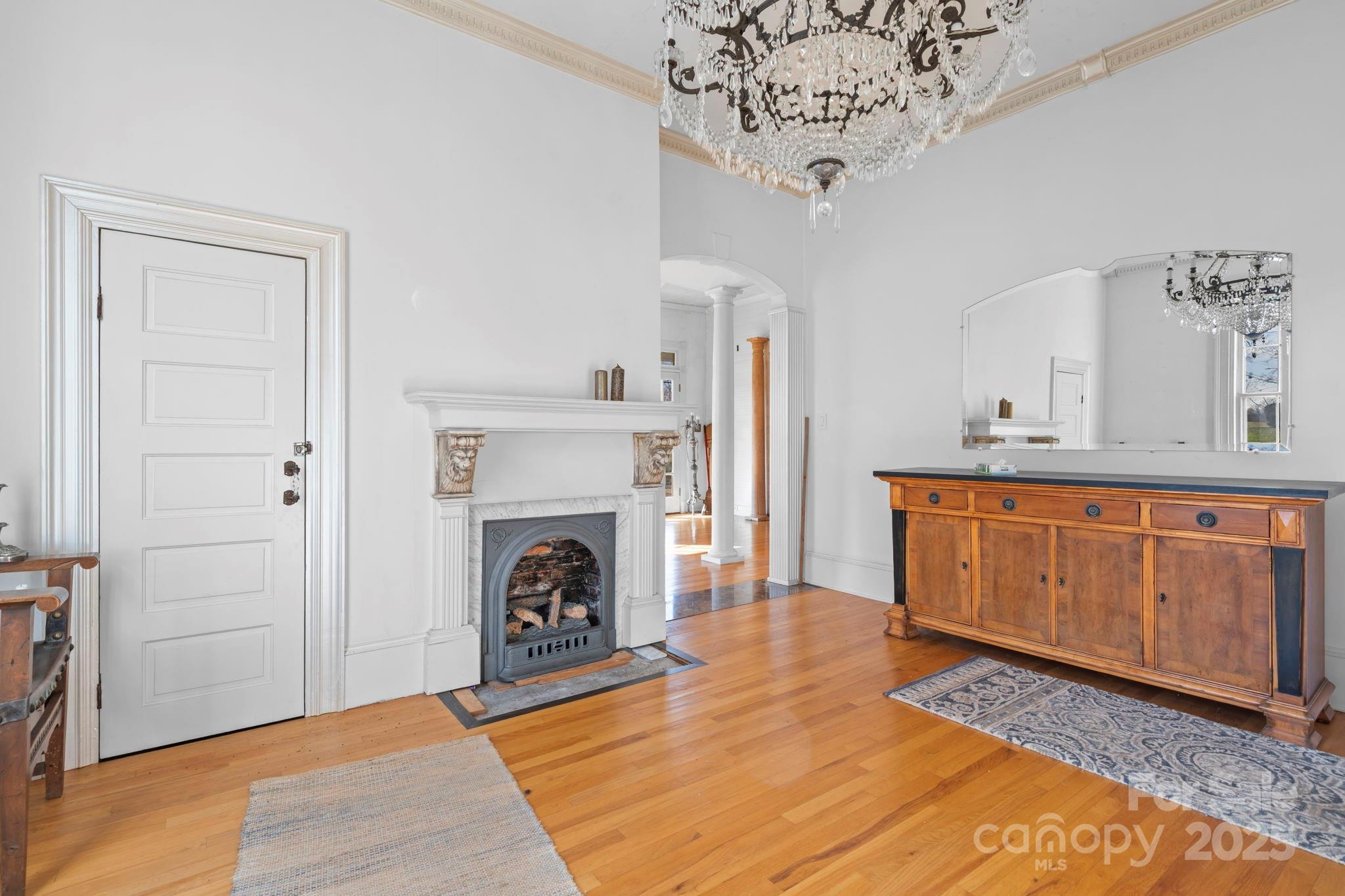 335 Eastview Street Morganton, NC 28655 - Photo 20 of 34 a living room with furniture a fireplace and a chandelier