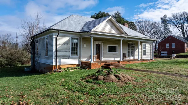 a front view of a house with a yard and porch