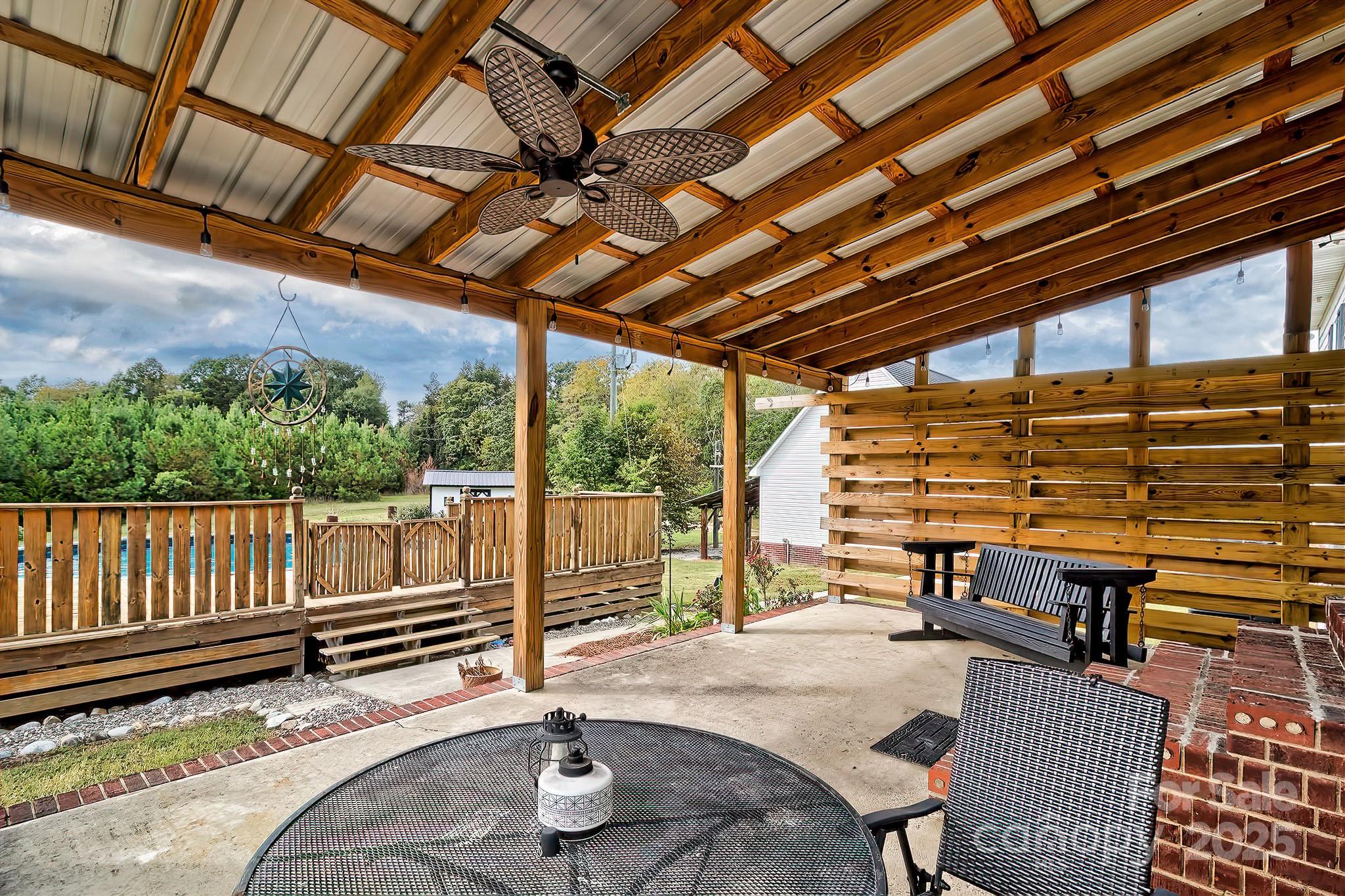 176 Griffin Road Pageland, SC 29728 - Photo 14 of 46 a backyard of a house with barbeque oven table and chairs