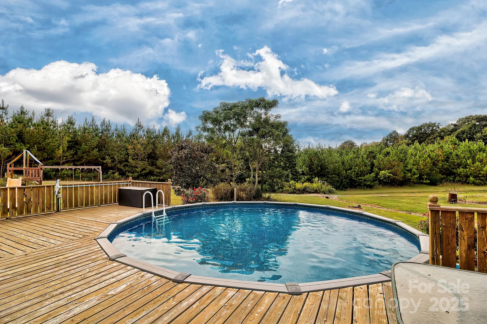 176 Griffin Road Pageland, SC 29728 - Photo 16 of 46 a view of a swimming pool with a lounge chair