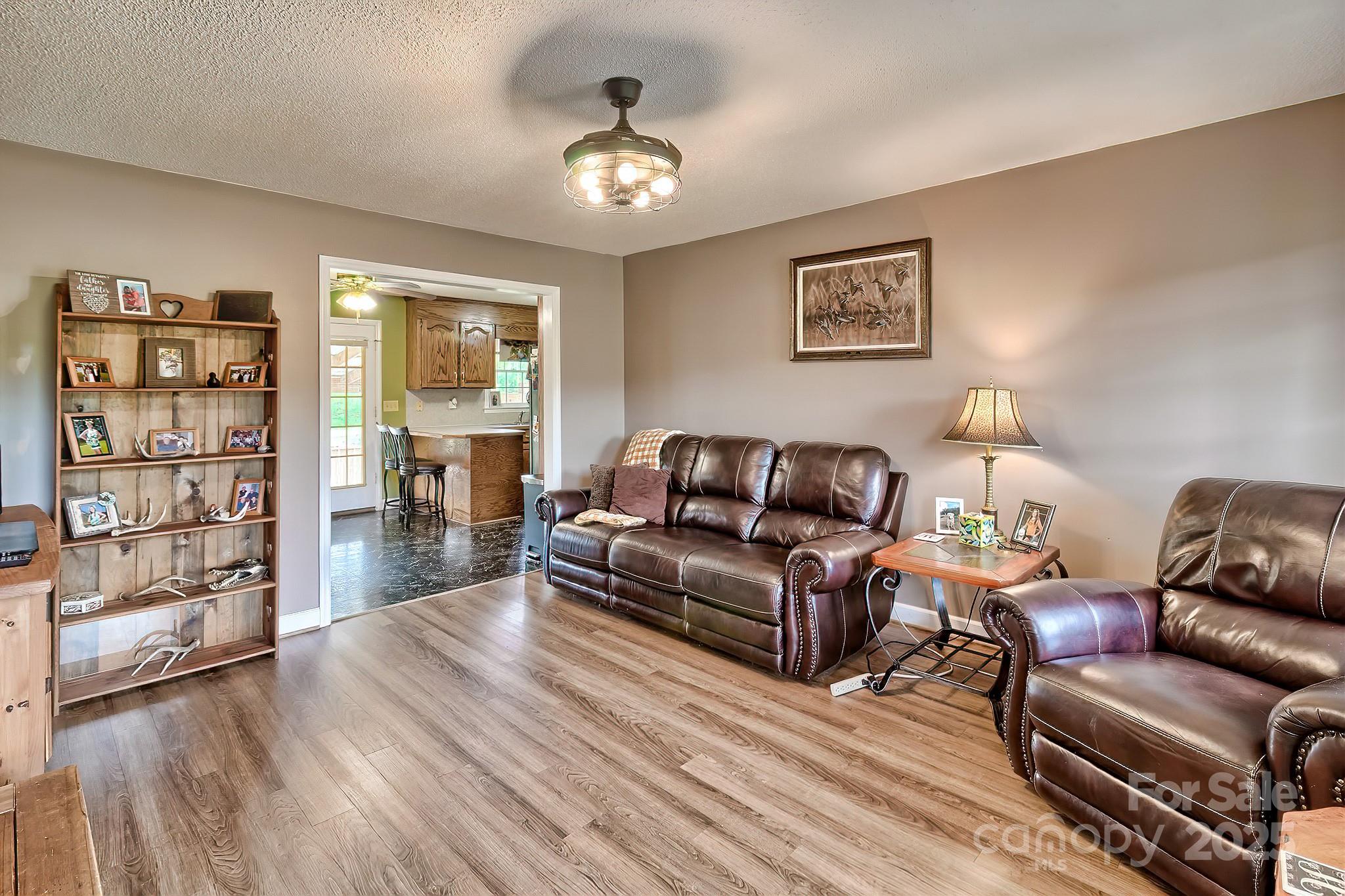 176 Griffin Road Pageland, SC 29728 - Photo 21 of 46 a living room with furniture and a book shelf