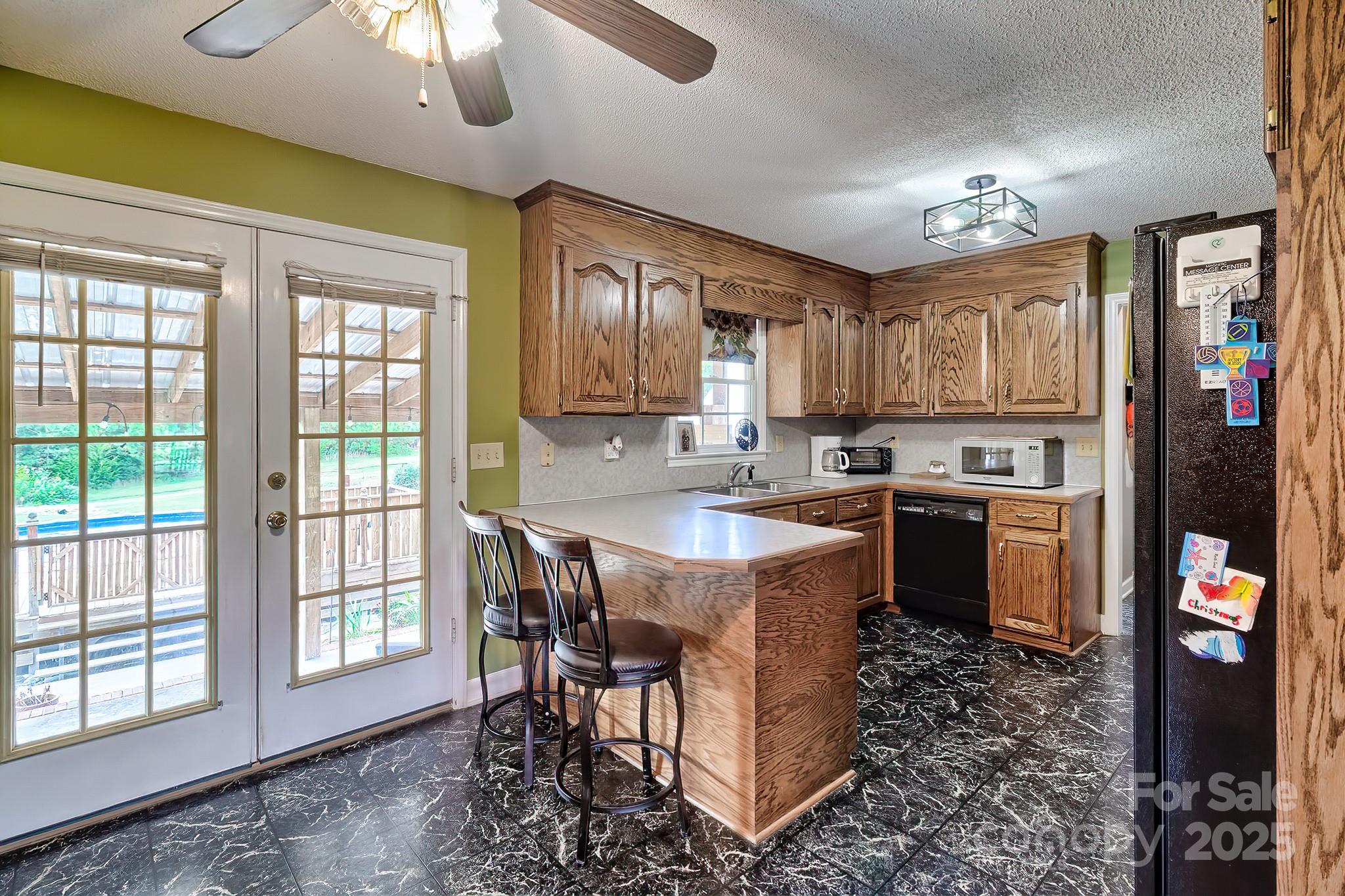 176 Griffin Road Pageland, SC 29728 - Photo 24 of 46 a kitchen with a table chairs refrigerator and cabinets